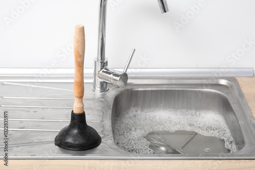 Metallic sink with soap wat...