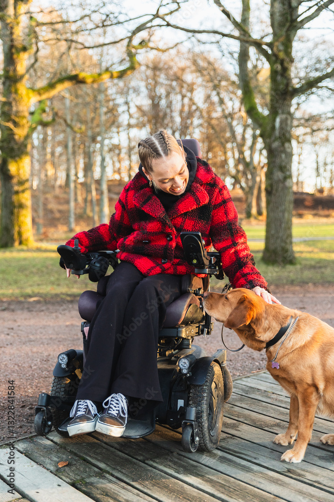 Woman in Wheelchair with Her Dog in the Park Woman in Wheelchair with Her Dog in the Park