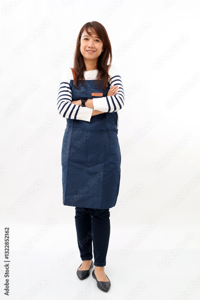 Full body young asian woman employee wear blue apron work in coffee shop hold hand crossed folded isolated on white background studio portrait small business startup concept Full body young asian woman employee wear blue apron work in coffee shop hold hand crossed folded isolated on white background studio portrait small business startup concept