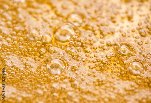 Golden syrup with air bubbles forming delicate pattern photo