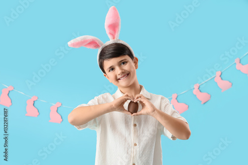 Cute boy in bunny ears with...