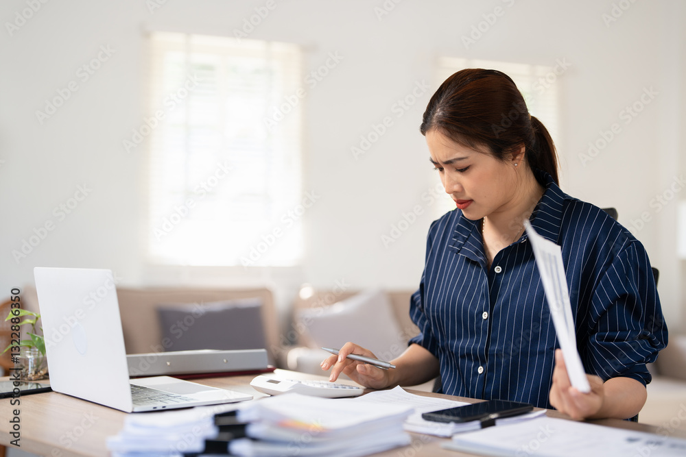 Young asian female work with financial papers at home count on calculator before paying taxes receipts online by laptop. woman planning budget finding chance for economy saving money. Young asian female work with financial papers at home count on calculator before paying taxes receipts online by laptop. woman planning budget finding chance for economy saving money.