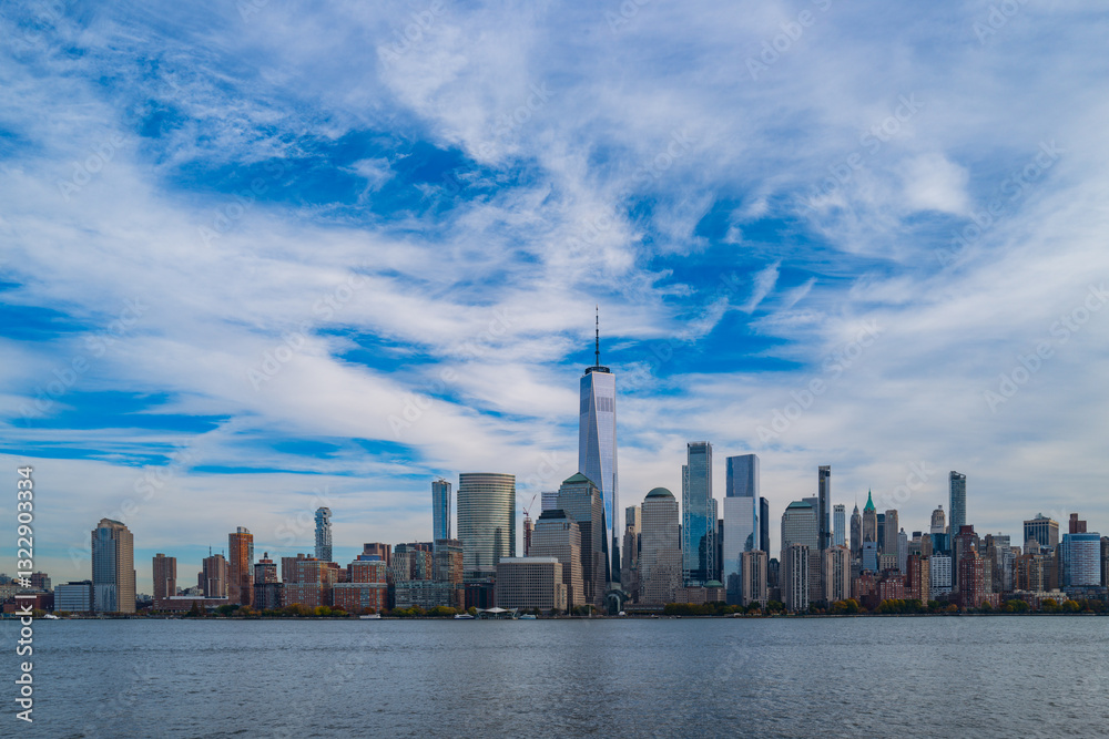 Obraz premium New York City cloudy skyline. NYC skyscrapers. Manhattan. NY cityscape with clouds. Downtown New York buildings. NYC skyline. New York harbor view. Skyscrapers in Manhattan. NYC downtown.