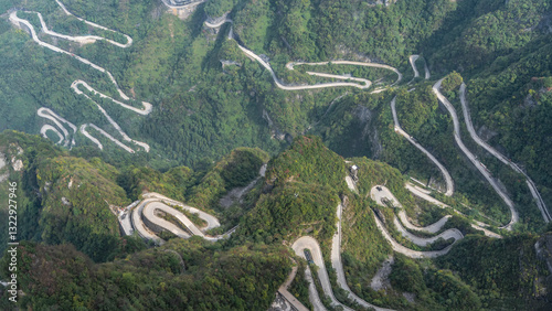 A unique mountain serpentine road with 99 turns. The highway winds along steep wooded slopes, twists, turns sharply. Top view. China. Tongtian Heavenly Highway. Zhangjiajie. Hunan Province photo