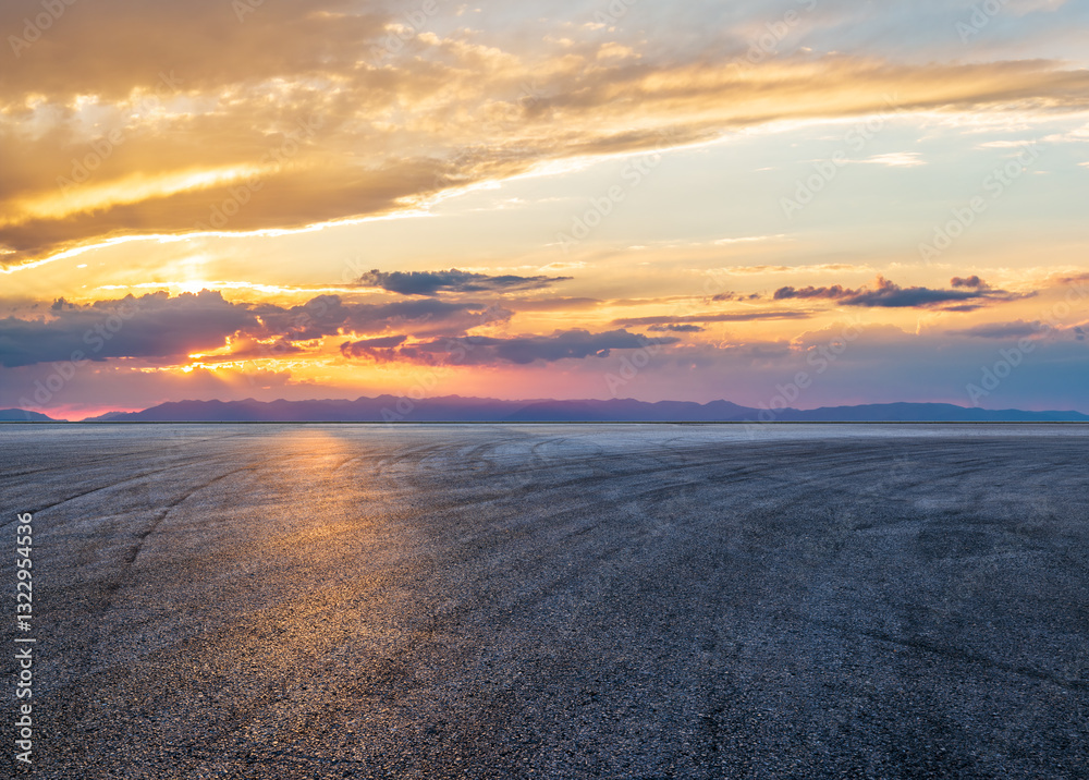 Empty asphalt road and distant mountain with beautiful sky clouds at sunset