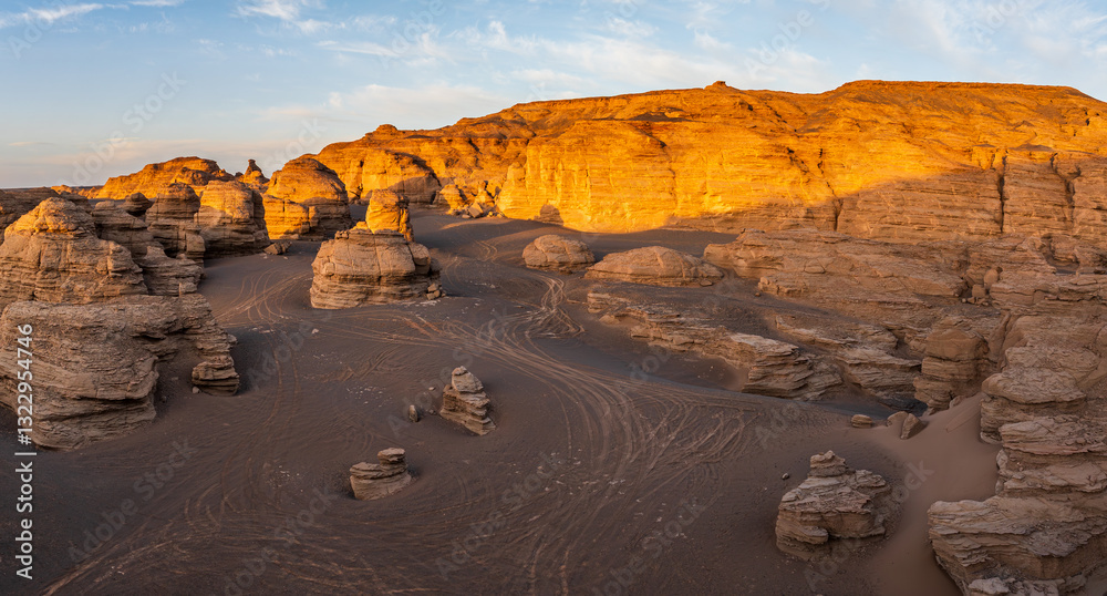Fototapeta premium Spectacular desert landscape with unique rock formations at sunset. The famous Dahaidao no man's land natural landscape in Xinjiang, China.