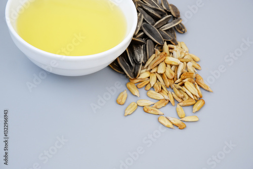 Fotografie Sunflower seeds and oil in bowl close up. Copy space for text.