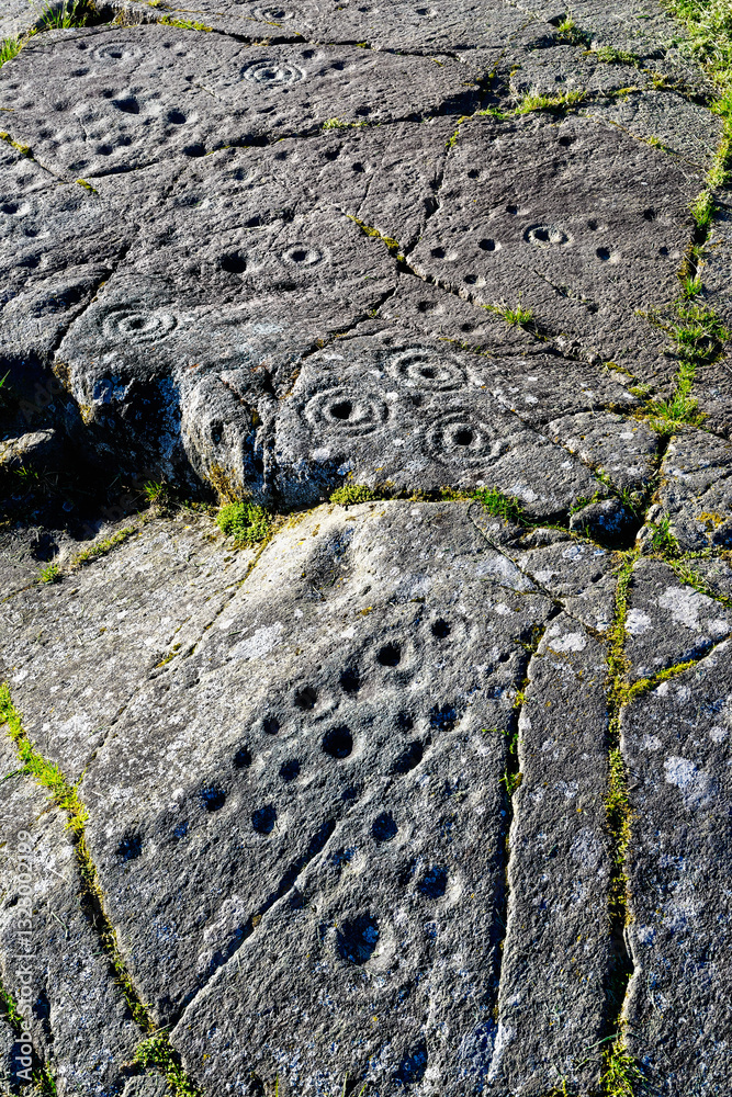 Cup and ring mark marks prehistoric Neolithic rock art on natural rock outcrop at Baluachraig in Kilmartin Valley, Argyll, Scotland, UK