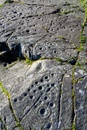 Obraz na płótnie Cup and ring mark marks prehistoric Neolithic rock art on natural rock outcrop at Baluachraig in Kilmartin Valley, Argyll, Scotland, UK w salonie