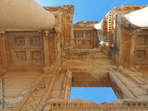 Wallpaper Mural A close-up view of the intricate stonework of the Ephesus ruins in Turkey, with a column in the foreground and a glimpse of the sky above. Torontodigital.ca