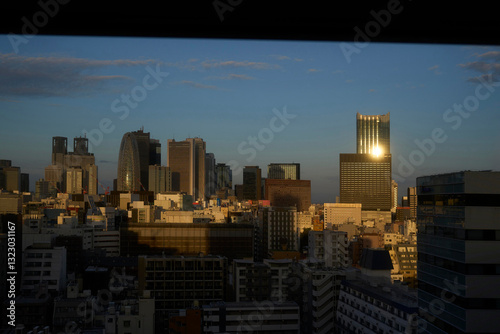 Sunset over Tokyo skyline revealing shimmering buildings and city photo