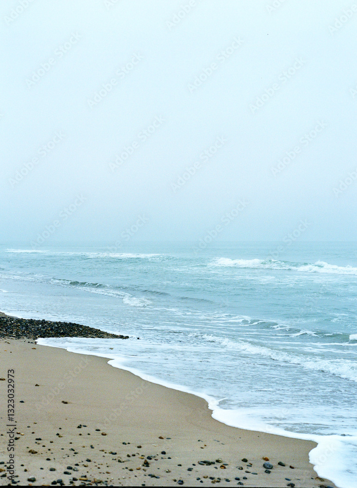 Winter beach with a sisty sea stretching to the horizon Winter beach with a sisty sea stretching to the horizon