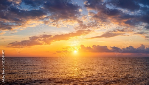 sunset sky clouds over sea in the evening with orange yellow sunlight horizon sea landscape background and sun down in golden hour summer season dusk