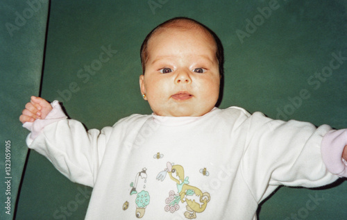 adorable portrait of baby looking at camera in 35 mm film photo