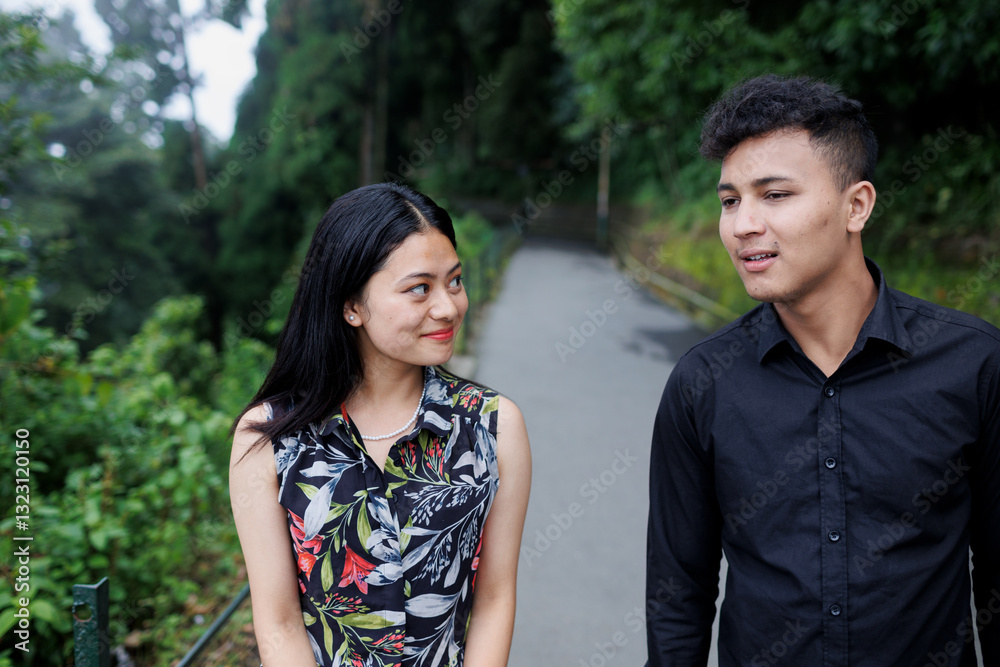 Happy young couple walking outdoors and talking Happy young couple walking outdoors and talking