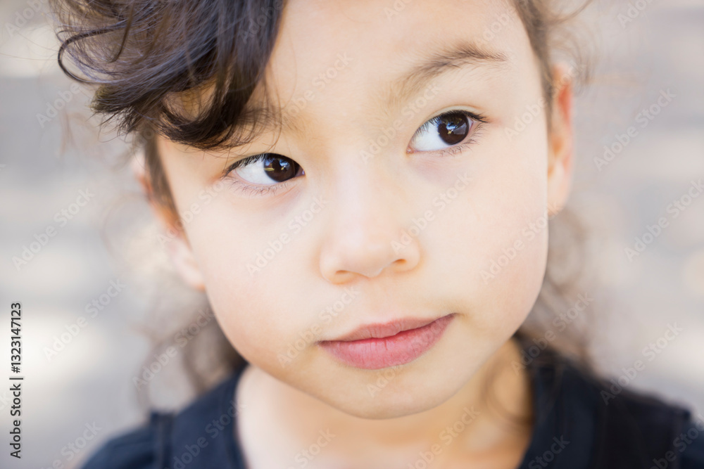 Mixed race Asian girl's face closeup - thinking Mixed race Asian girl's face closeup - thinking