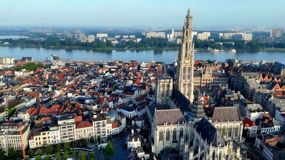 Summer Morning in Antwerp: A High-Angle Aerial View of the City, Centered on the Majestic Cathedral of Our Lady with Its Towering Spire, Overlooking the River Scheldt and the City's Historic Buildings