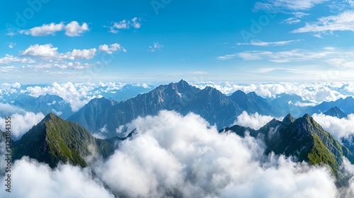 Majestic Mountain Peaks Emerging From Clouds Under Bright Blue Sky