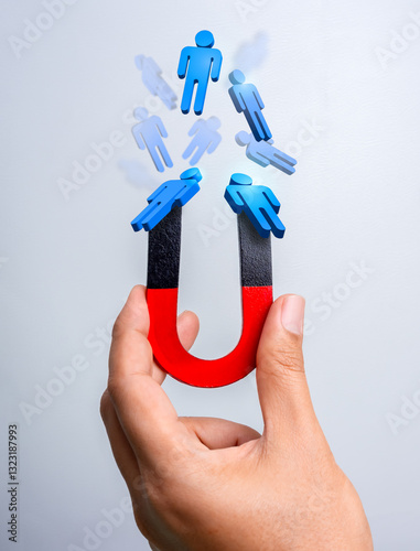 Business digital marketing, target audience, attract leads and customers concept. 3d human figure attracted by magnet in hand on blue background. Business team building, recruitment, hiring concept.