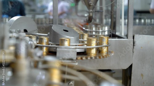 Automatic production line is filling canned ketchup Food factory industry production plant.