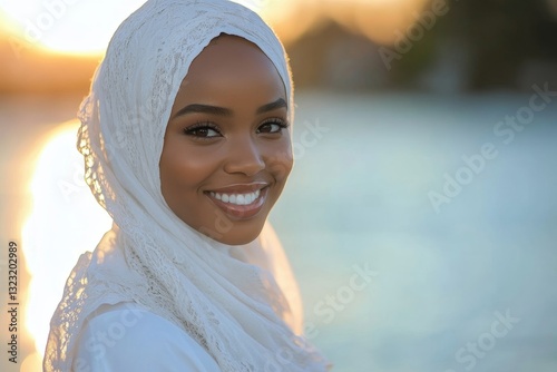 Portrait of beautiful african muslim woman in hijab smiling at camera outside