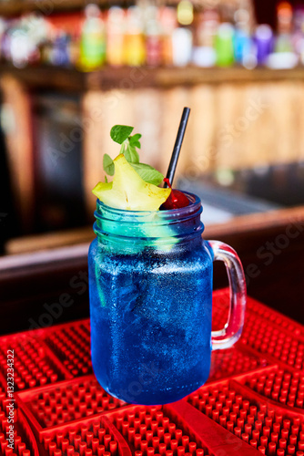 Blue Tropical Drink with Starfruit and Cherry Garnish