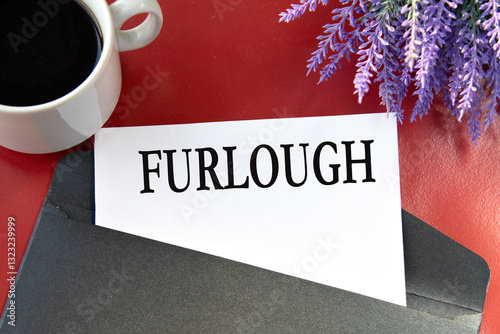 FURLOUGH - the word on white paper are on a black envelope on a red background.