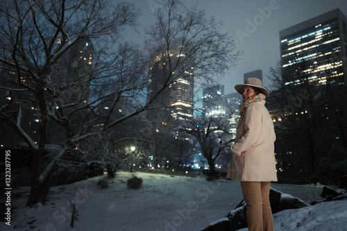 Woman Overlooking Snowy Central Park with NYC Skyline