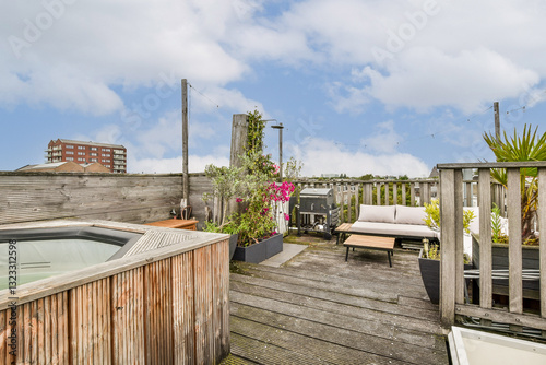 A charming rooftop terrace featuring a hot tub, stylish seating, and vibrant plants, offering a perfect escape for relaxation and socializing.