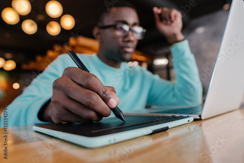 Creative professional using tablet and laptop in modern workspace photo