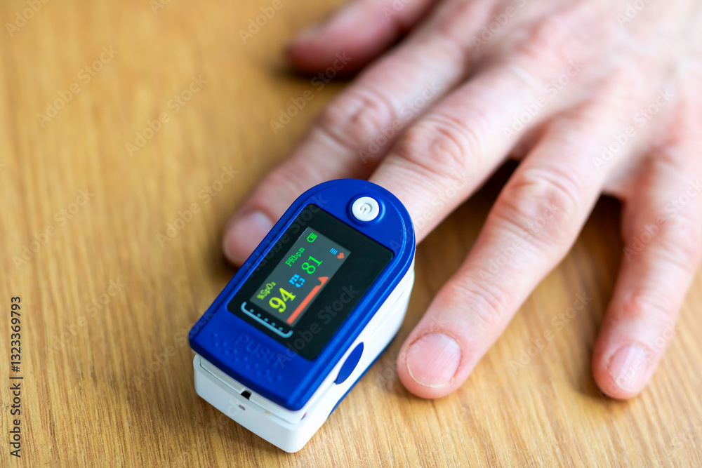 A person is using a pulse oximeter to monitor oxygen levels