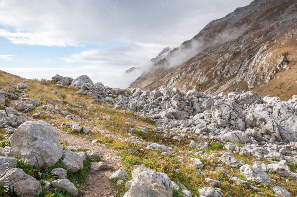 Picturesque mountain range covered with huge boulders and Fisht-Oshten massif in the background, Adygea, Russia