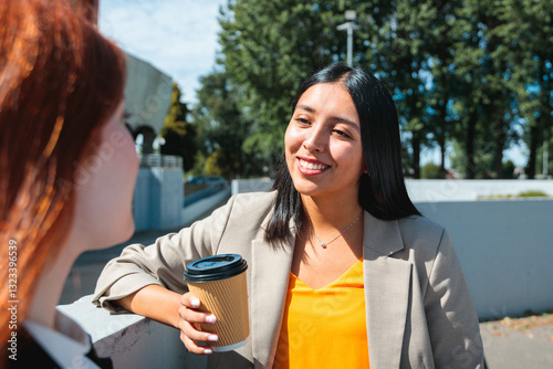 Businesswomen chatting in a coffee break outdoors