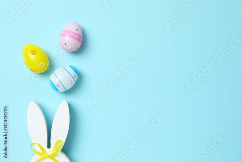 Happy Easter. Colorful eggs with bunny ears on color background, space for text or advertising