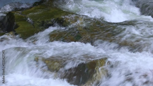 The water from the creek runs through the rocks