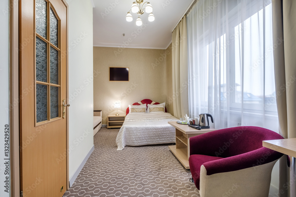 Fototapeta premium double bed with pillows in interior with night lamp in hotel room..