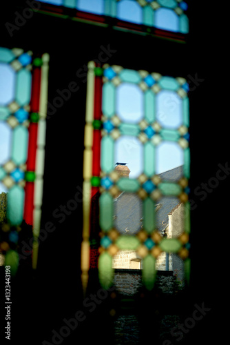 Wallpaper Mural Sunlight streaming through colorful stained glass onto roofs and chimney  outdoor. Hauts-de-France, France Torontodigital.ca