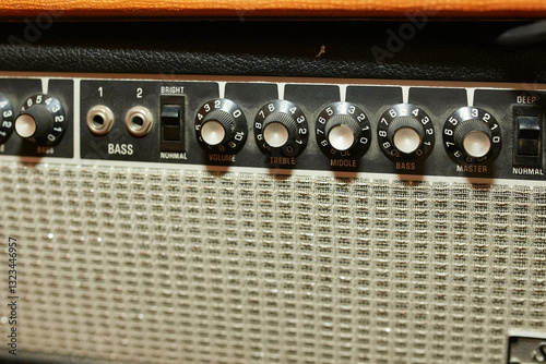 Close-up of a vintage guitar amplifier with detailed control knobs and inputs.