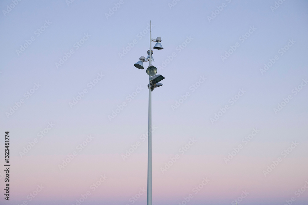 Tall streetlight with multiple lamps against a gradient pink and blue sky at twilight. Lanzarote, Spain Tall streetlight with multiple lamps against a gradient pink and blue sky at twilight. Lanzarote, Spain