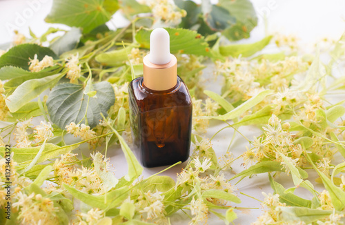 Linden flowers and essential oil used in hair treatment concept, herbal medicine