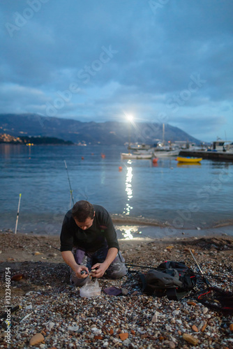 Man prepares bait for catching crabs  photo