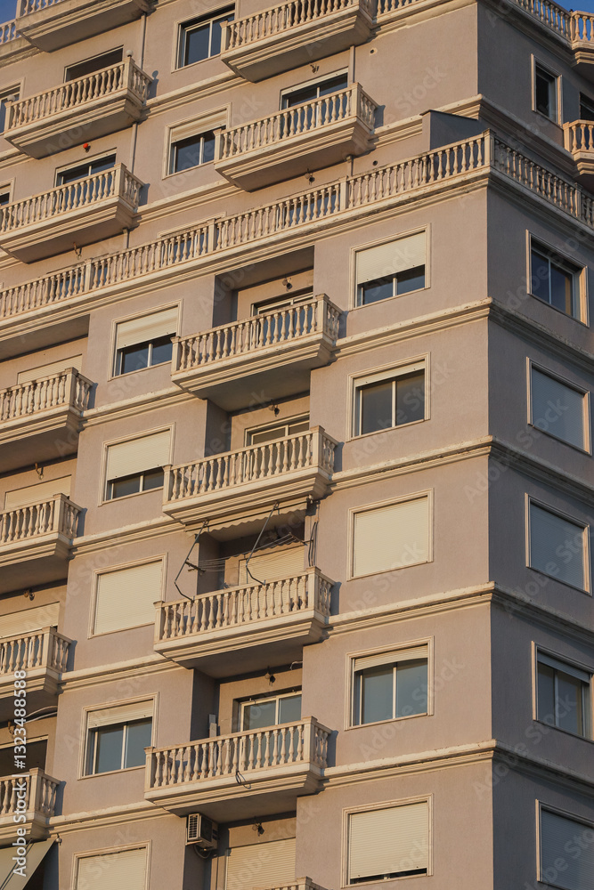 Balconies and architecture of a residential building in Albania during sunset capturing light and shadow details Balconies and architecture of a residential building in Albania during sunset capturing light and shadow details