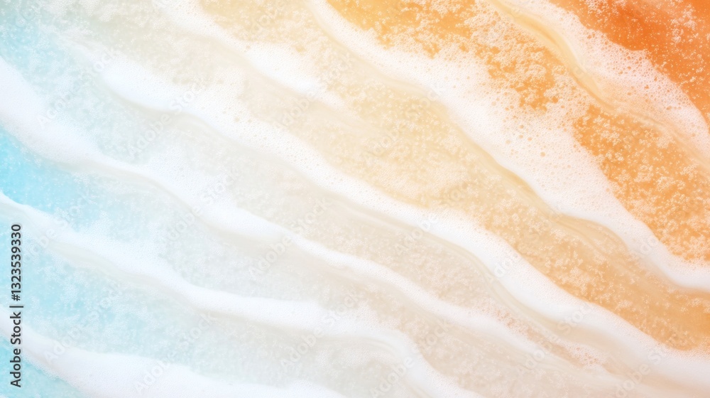 Obraz premium Waves rolling onto a sandy beach during sunset creates a beautiful blend of colors in the sky and reflections on the water