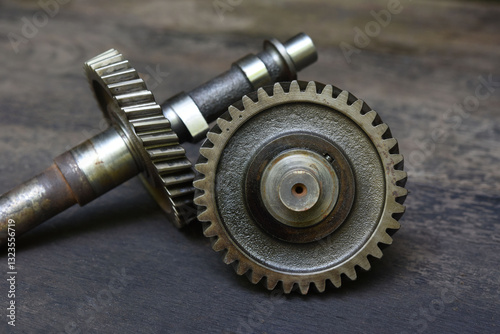 Disassembled  transmission gear of  a  small 4 stroke engine on the table . Fix and maintenance engine part in service shop .
