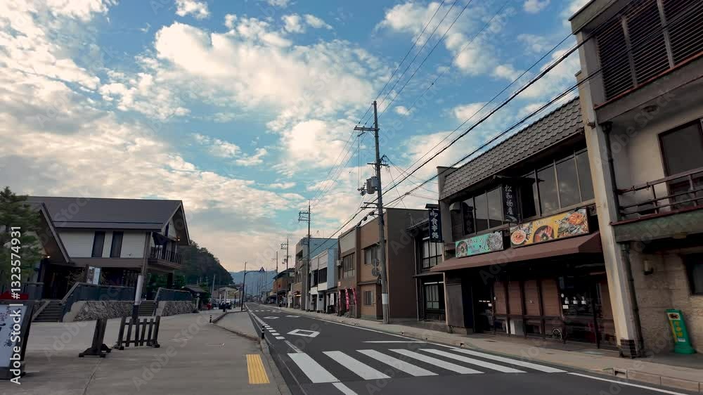 Empty street with traditional Japanese architecture and restaurants outside Amanohashidate Station in Kyoto, Japan, under a beautiful cloudy sky Empty street with traditional Japanese architecture and restaurants outside Amanohashidate Station in Kyoto, Japan, under a beautiful cloudy sky