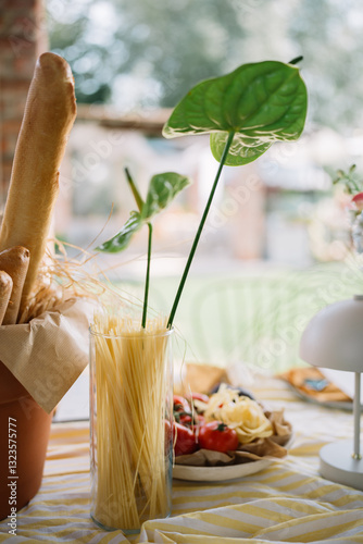 Spaghetti in a vase with greenery photo