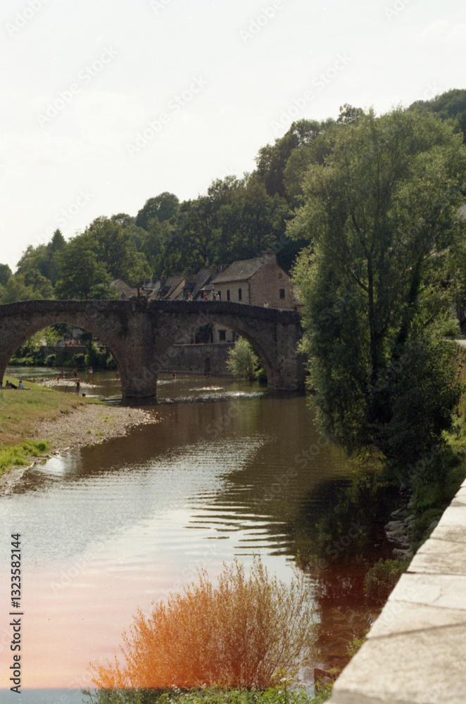 Old stone bridge crossing the river in a French village Old stone bridge crossing the river in a French village