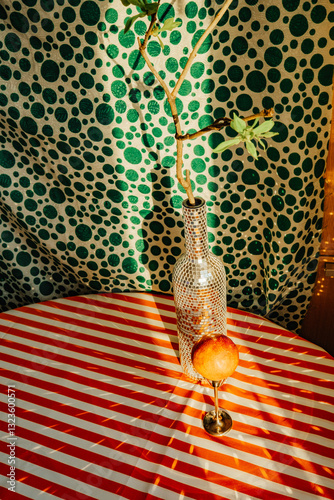 Decorative table setting with bottle and fruit in a vibrant room photo