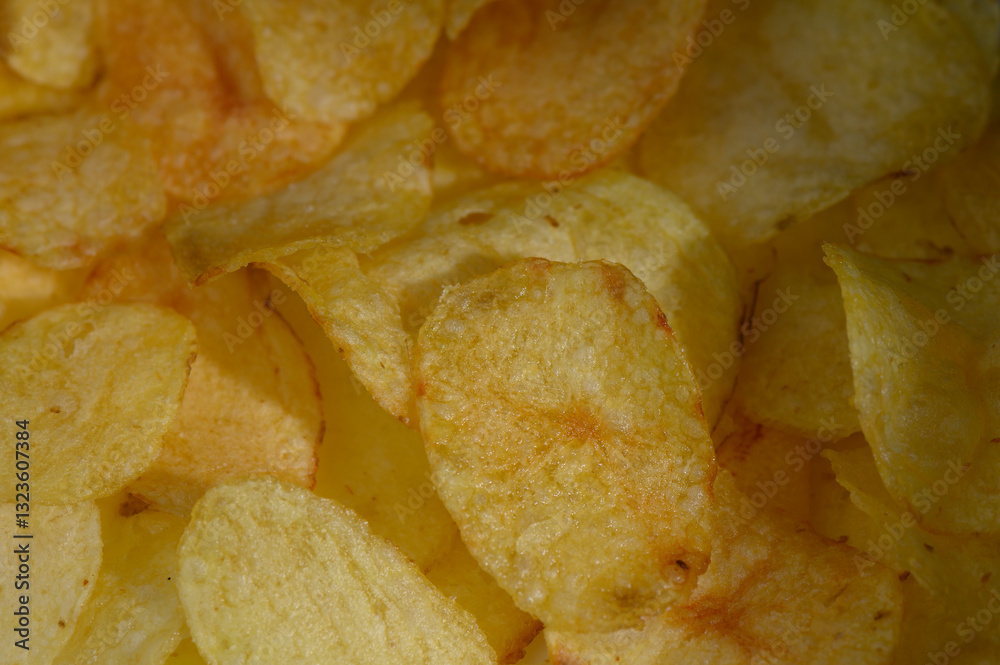 Crunchy golden potato chips scattered in a bowl create a tempting snack experience at any gathering Crunchy golden potato chips scattered in a bowl create a tempting snack experience at any gathering