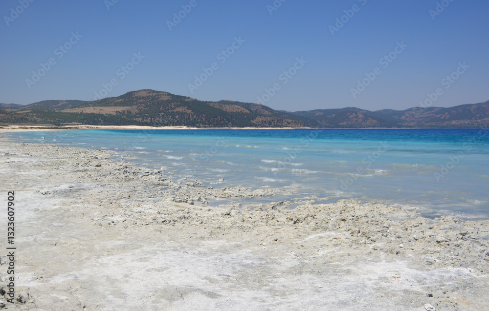 Turquoise Lake Shore with Mountains Under Blue Sky Turquoise Lake Shore with Mountains Under Blue Sky